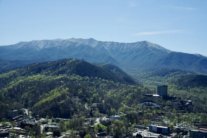 smoky mountain landscape of gatlinburg in april with snow in the background on the mountains